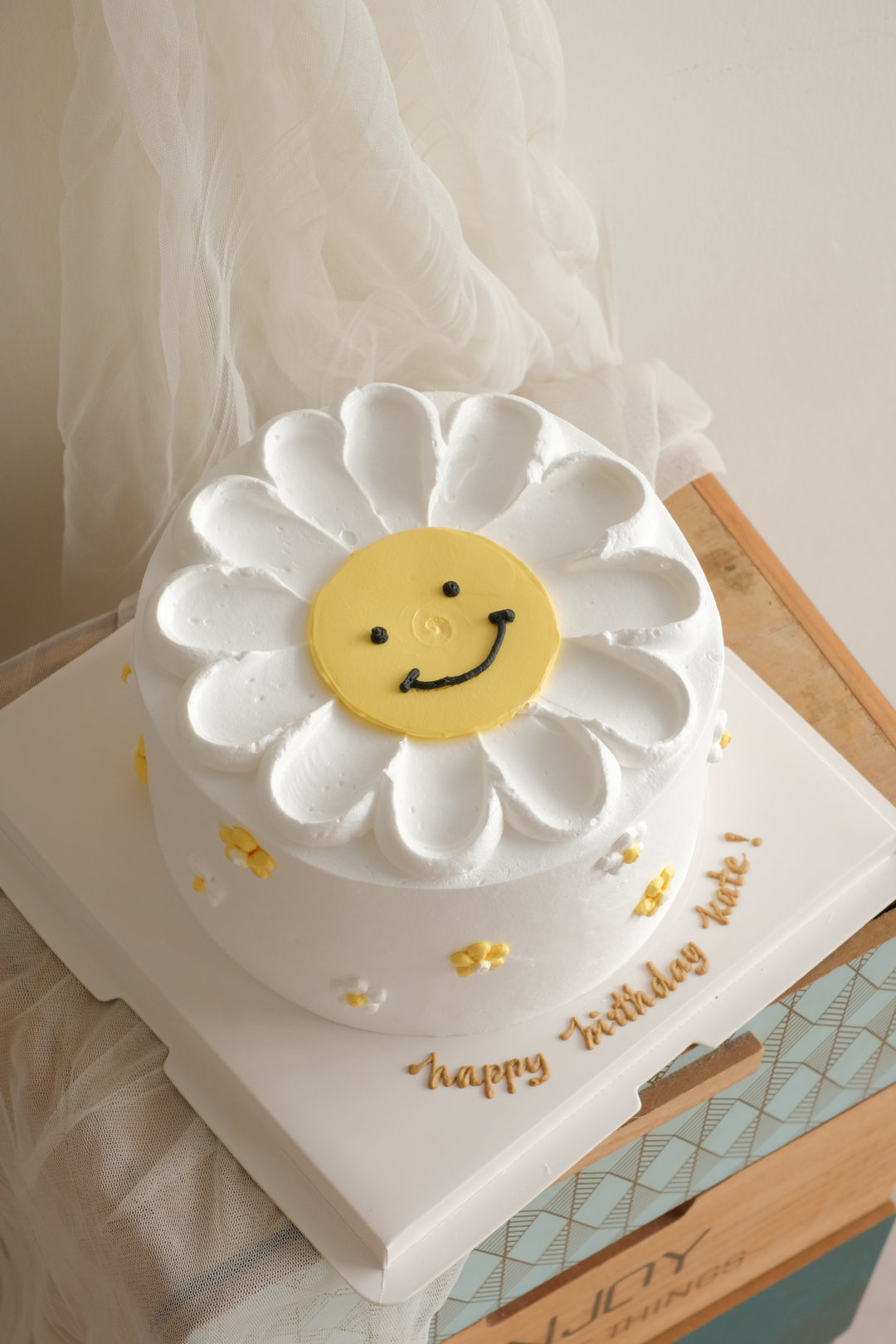 Smiley Daisy Cake — white daisy buttercream cake with a yellow smiley face centre, Bamboo Green Florist Penang