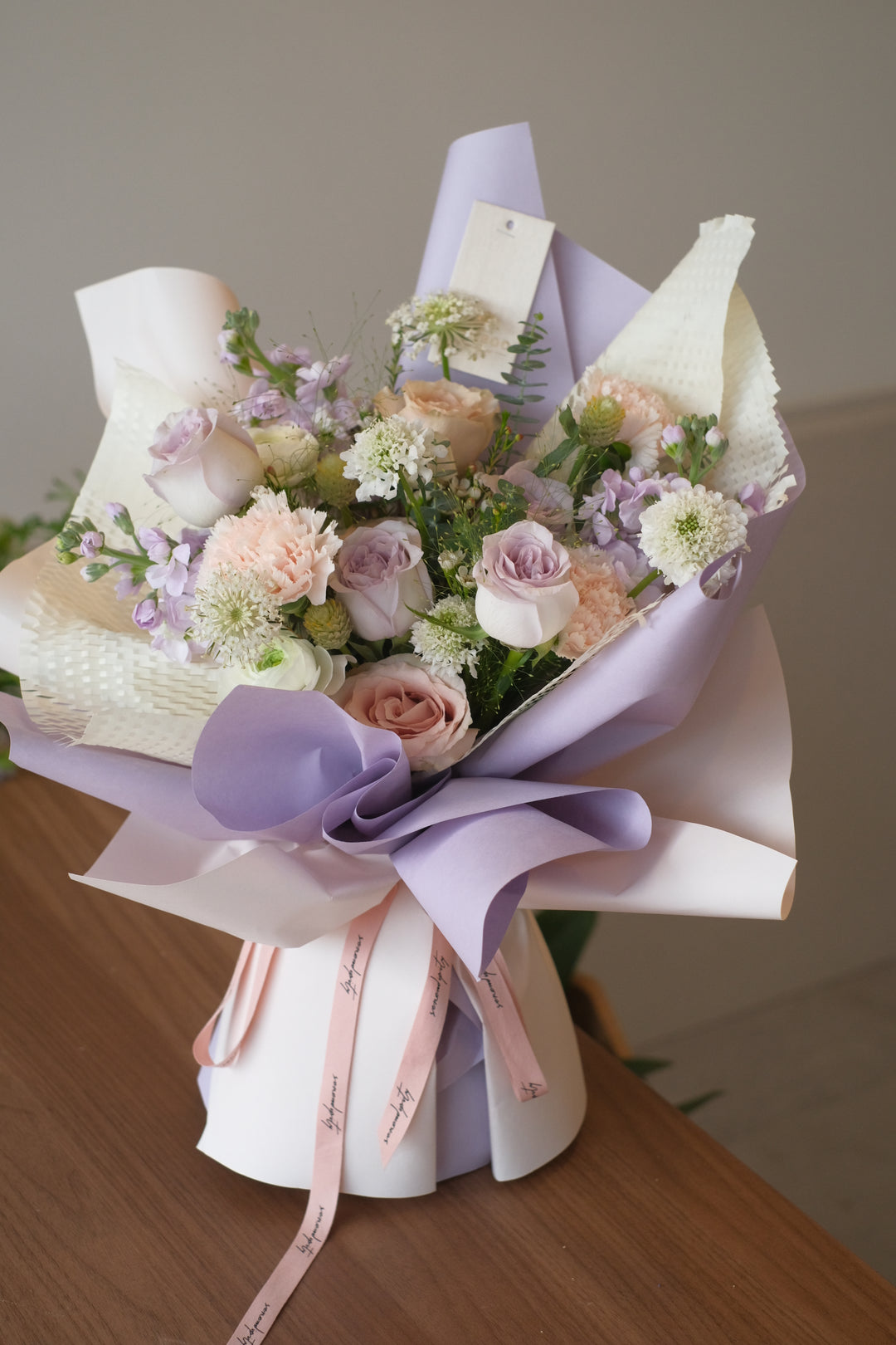 Exquisite bouquet of purple pastel flowers being delivered in Penang, symbolizing elegance and grace in floral arrangements."