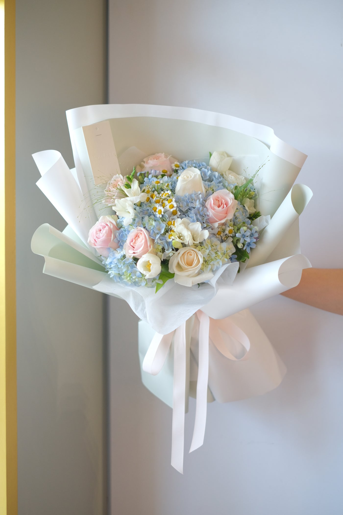 graduation bouquet featuring pastel-coloured roses, cappuccino roses, and more