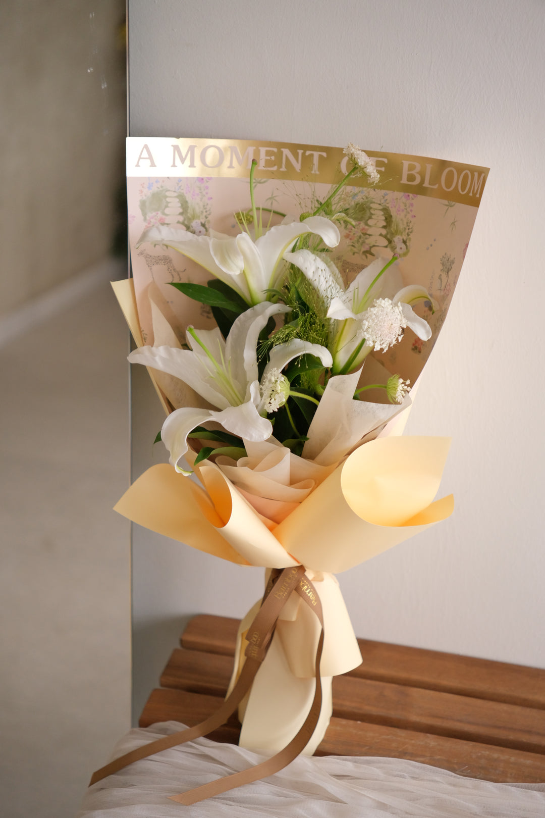 lilies bouquet — white oriental lilies, lace flower and panicum grass in a butter-yellow wrap with brown ribbon, Bamboo Green Florist Penang