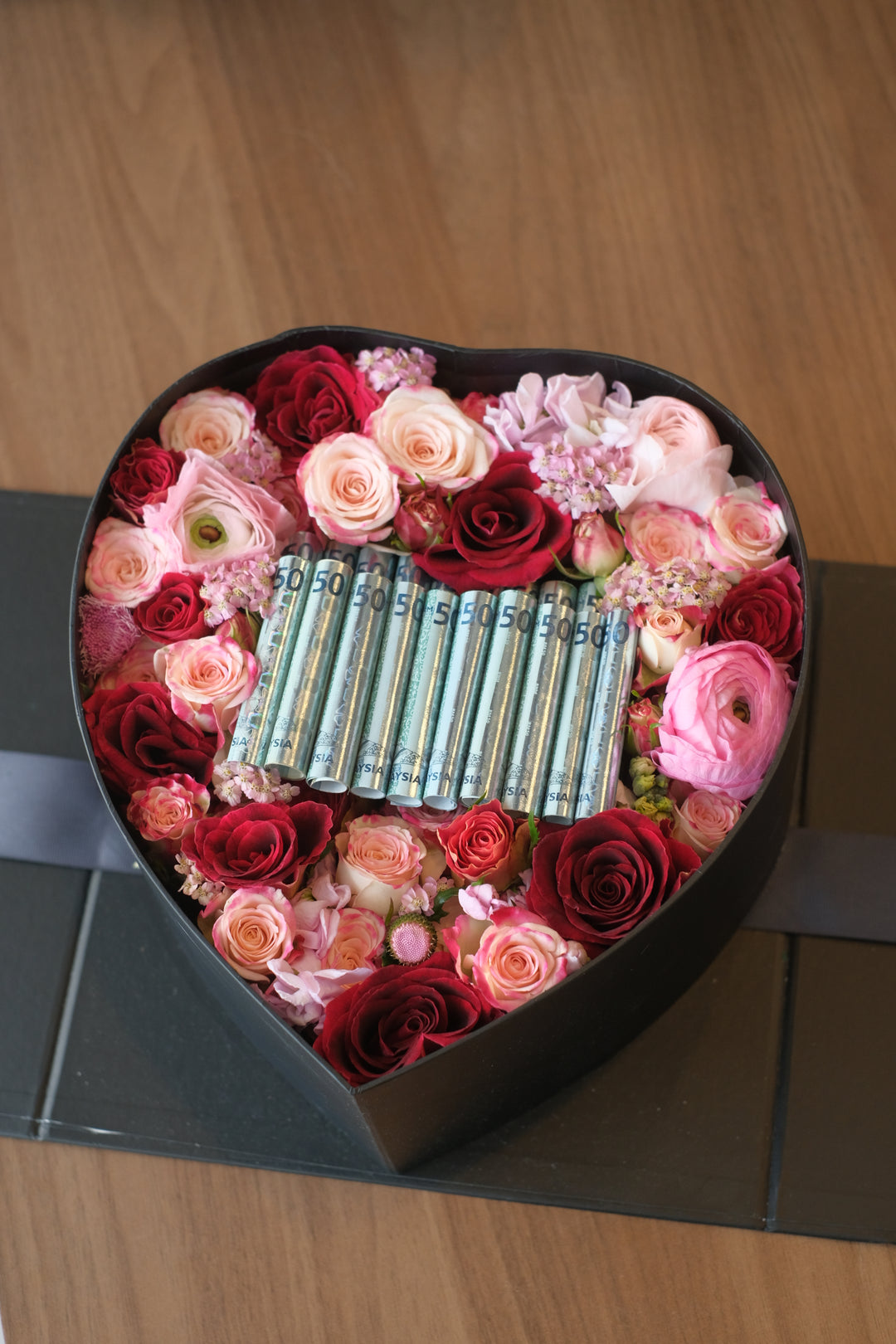 cash and flowers in bloom box