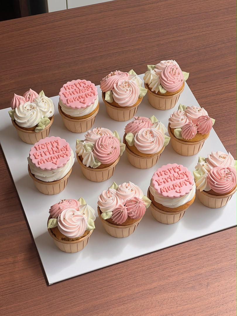 Set of twelve hand-piped pink and cream rose cupcakes with gold pearls and a personalised birthday message, by Bamboo Green Florist, best florist in town