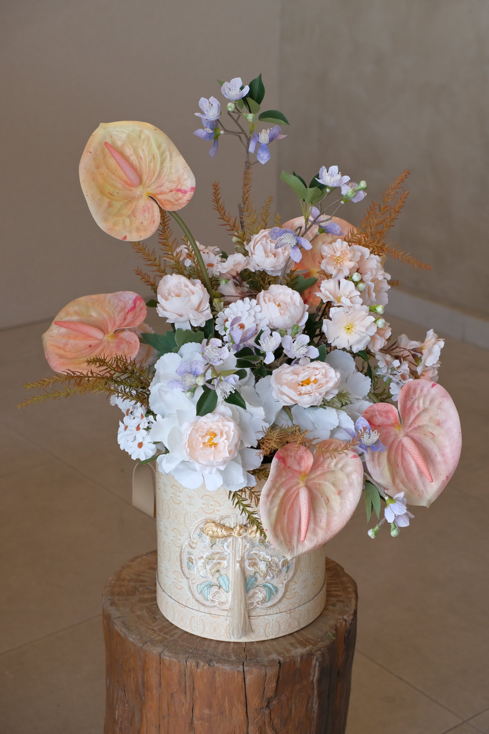 Elegant artificial flowers in oriental-inspired box with tassel