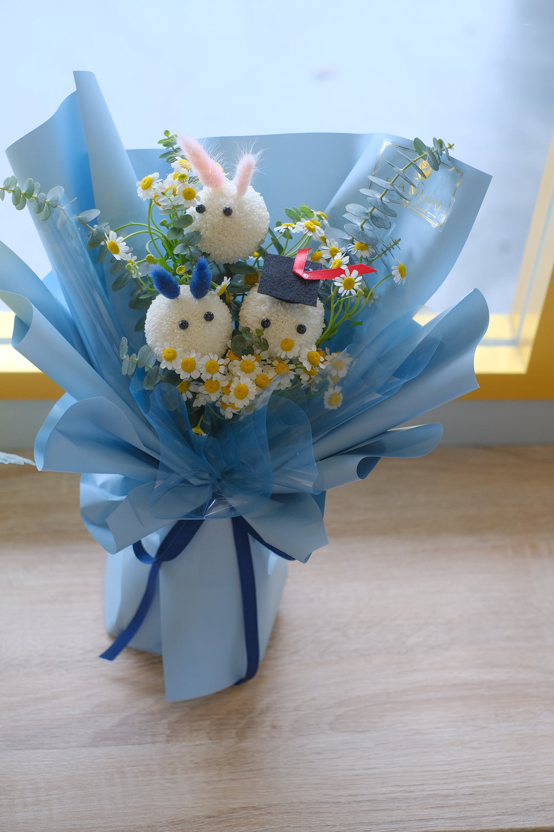 unique flower arrangements ideas, a sunflowers bouquet complemented with pastel blue flower wrapper, florist online