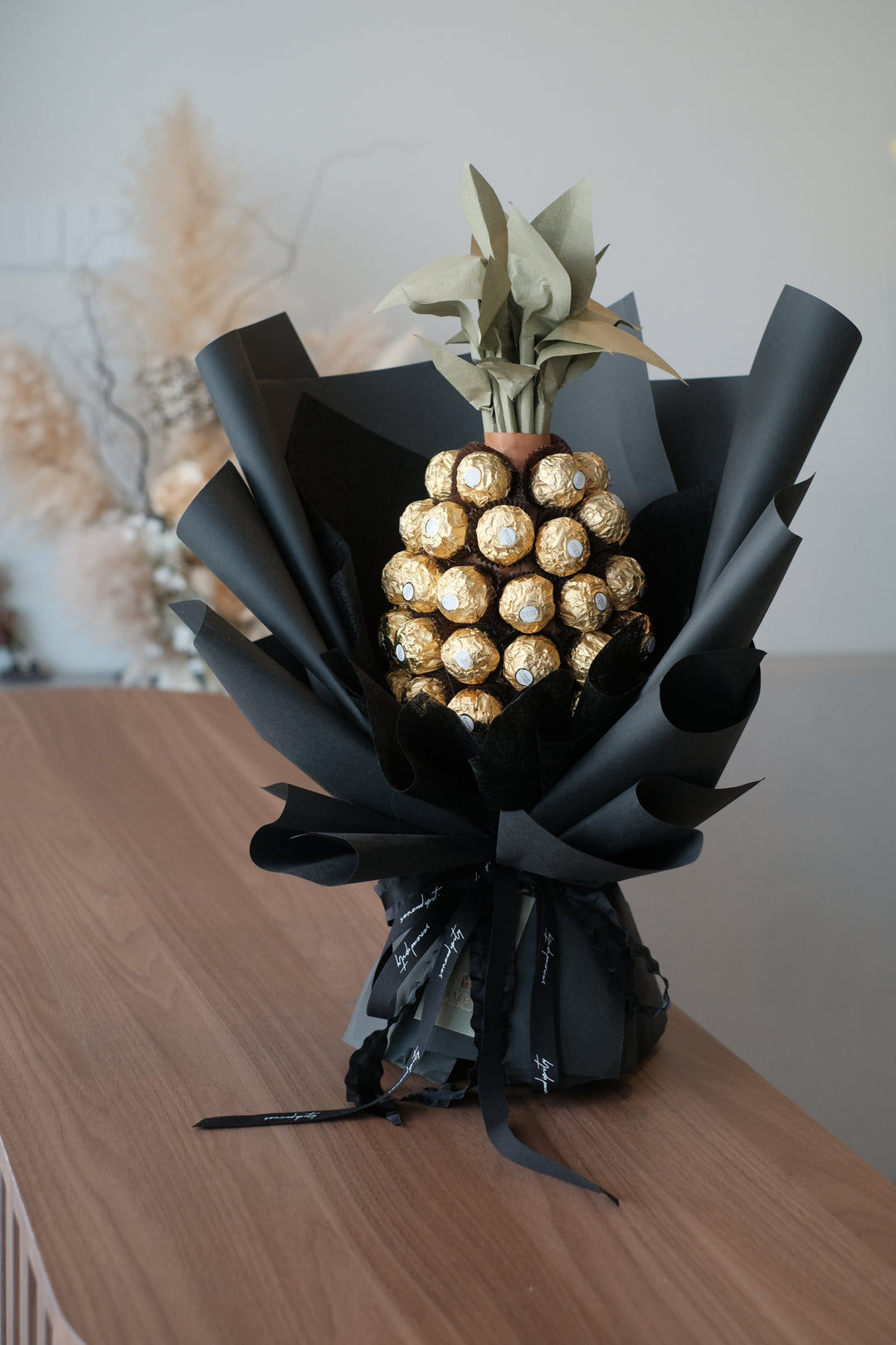 A sweet perfection note featuring a delicious arrangement of approximately 56 pieces of Ferrero Rochers presented in the form of a pineapple by bamboo green florist, penang florist