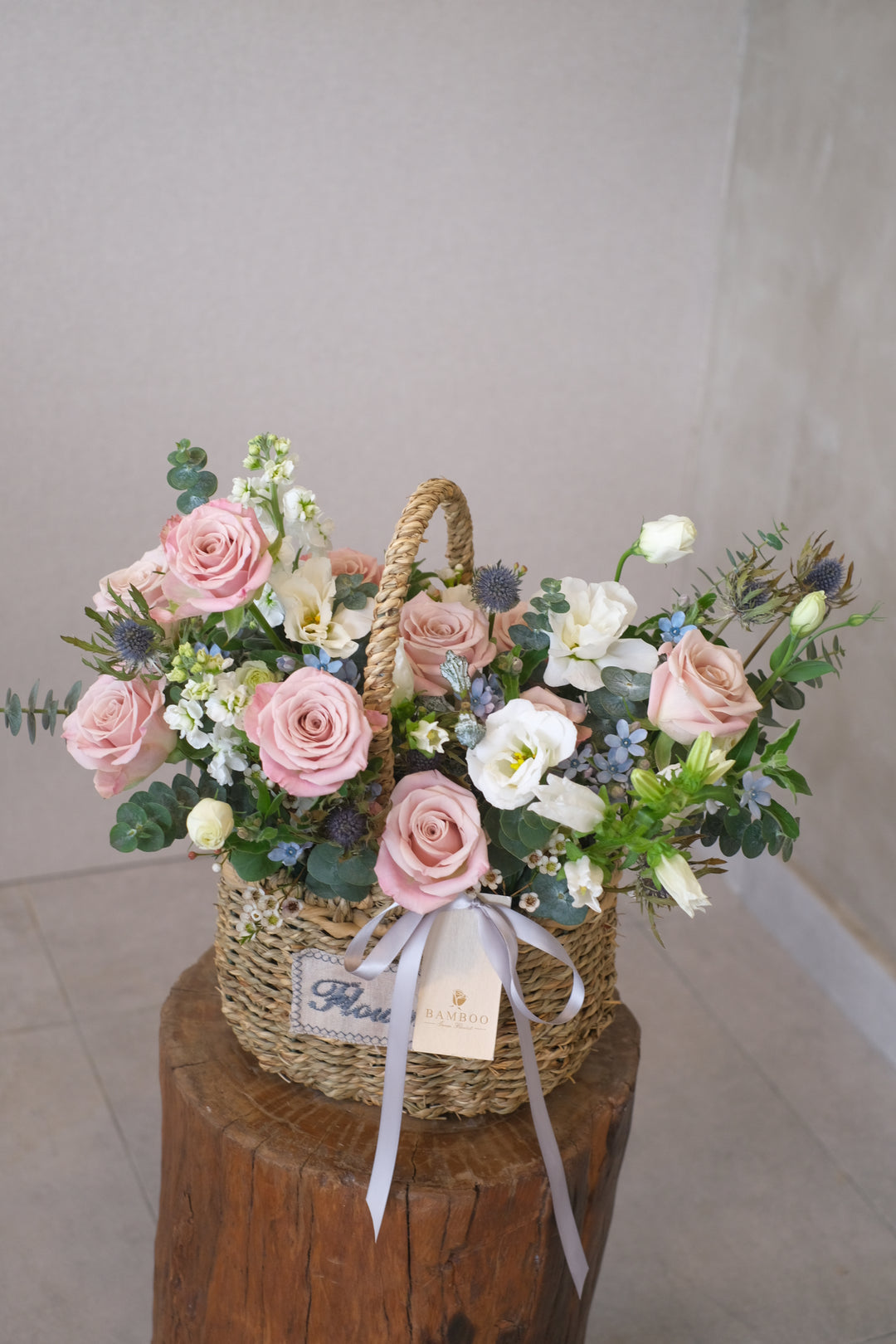 "A wicker basket filled with an assortment of fresh, vibrant blooms, reflecting serenity and beauty."