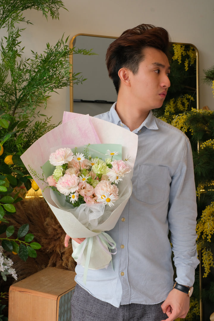 Soft pink carnation and daisy bouquet for Mother’s Day, pastel wrapping, elegant hand-tied flowers for mum
