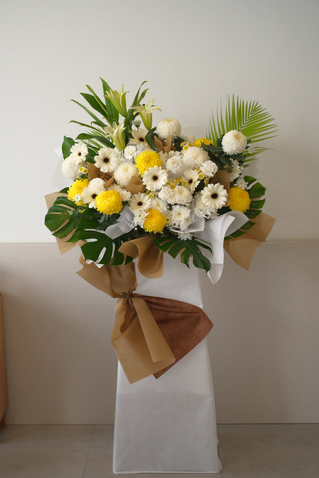 yellow chrysnahtmeum mounted in stand for condolences flowers occasions in penang