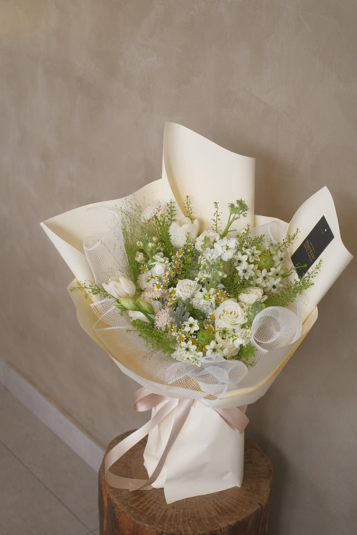 chamomile roses tulips bouquet in cream wrap