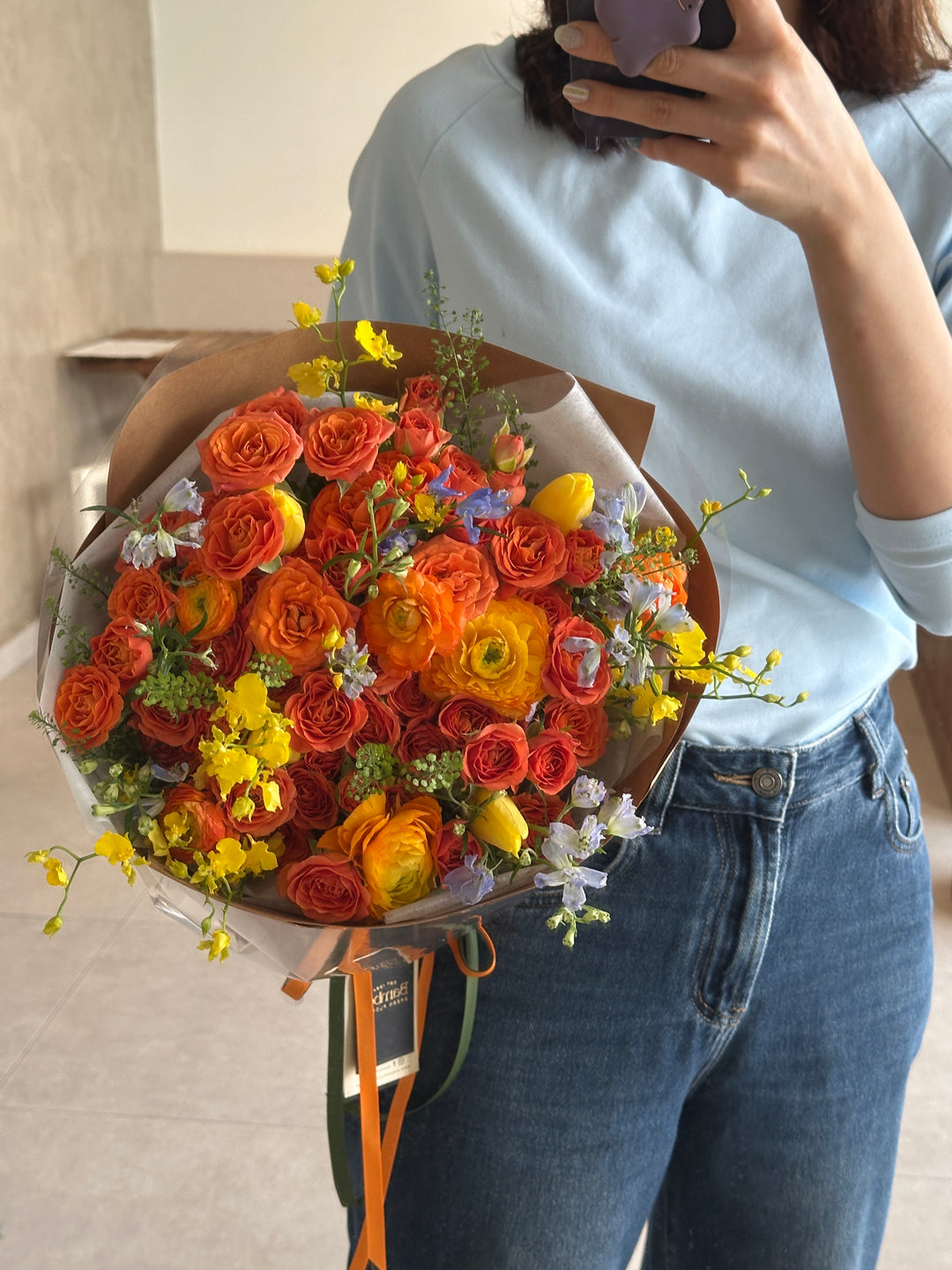 Omakase Orange bouquet featuring orange roses, ranunculus, yellow orchids, and blue delphinium – Bamboo Green Florist Penang