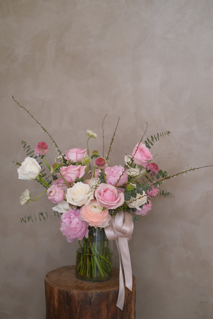 Elegantly arranged in a glass vase, this bouquet combines the soft glow of pink romance blooms. Perfect for housewarmings, birthdays, baby showers, or engagements. A timeless expression of care and love. Penang florist, same day delivery available