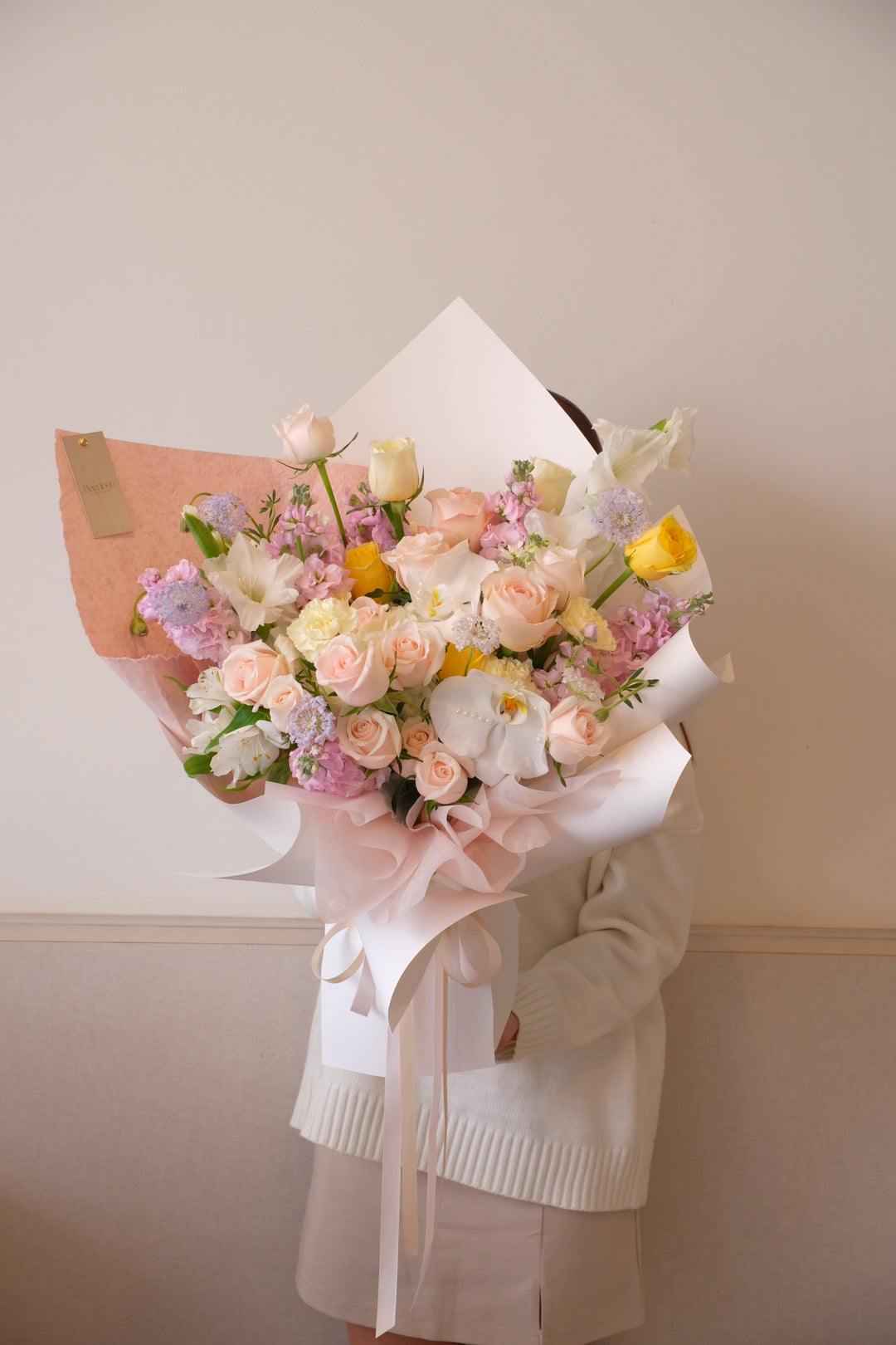 Omakase soft elegant bouquet with pastel roses and orchids in signature sculpted wrap | Bamboo Green Florist Penang | Leave it up to us floral design Malaysia.”