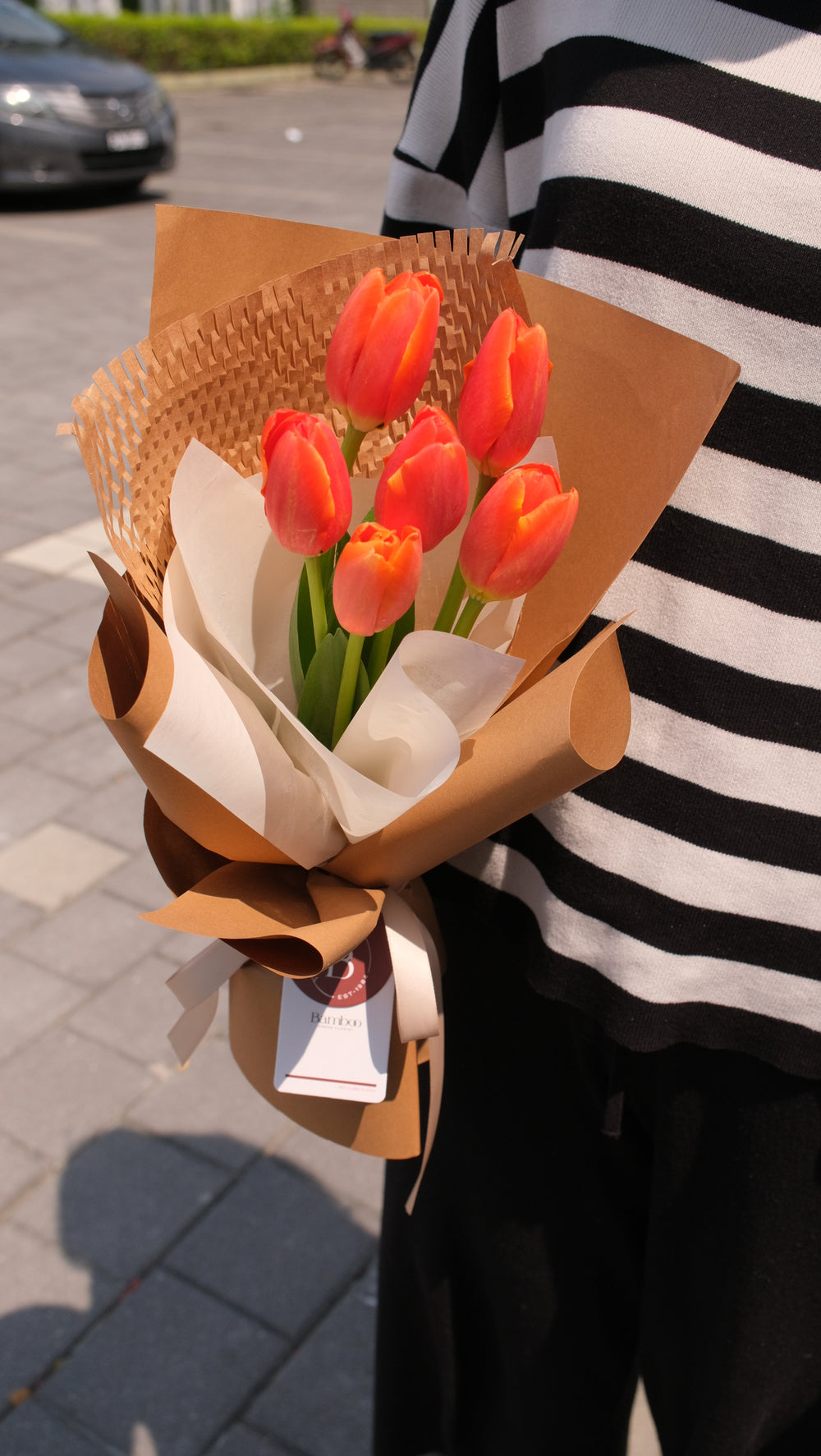 A stunning bouquet of 6 vibrant orange tulips, symbolizing warmth, enthusiasm, and admiration. Perfect for any joyful occasion. Order online from Bamboo Green Florist, your trusted Penang florist.
