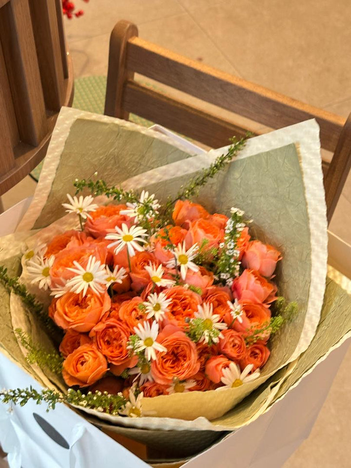 A radiant bouquet inspired by sunrise and citrus, with warm apricot-orange hues exuding joy and vibrance. Perfect for celebrating love and special moments. Order online from Bamboo Green Florist, your trusted Penang florist.