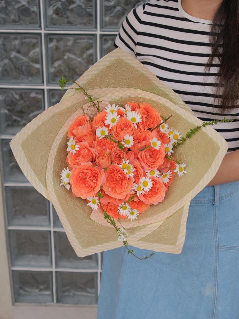 A radiant bouquet inspired by sunrise and citrus, with warm apricot-orange hues exuding joy and vibrance. Perfect for celebrating love and special moments. Order online from Bamboo Green Florist, your trusted Penang florist.