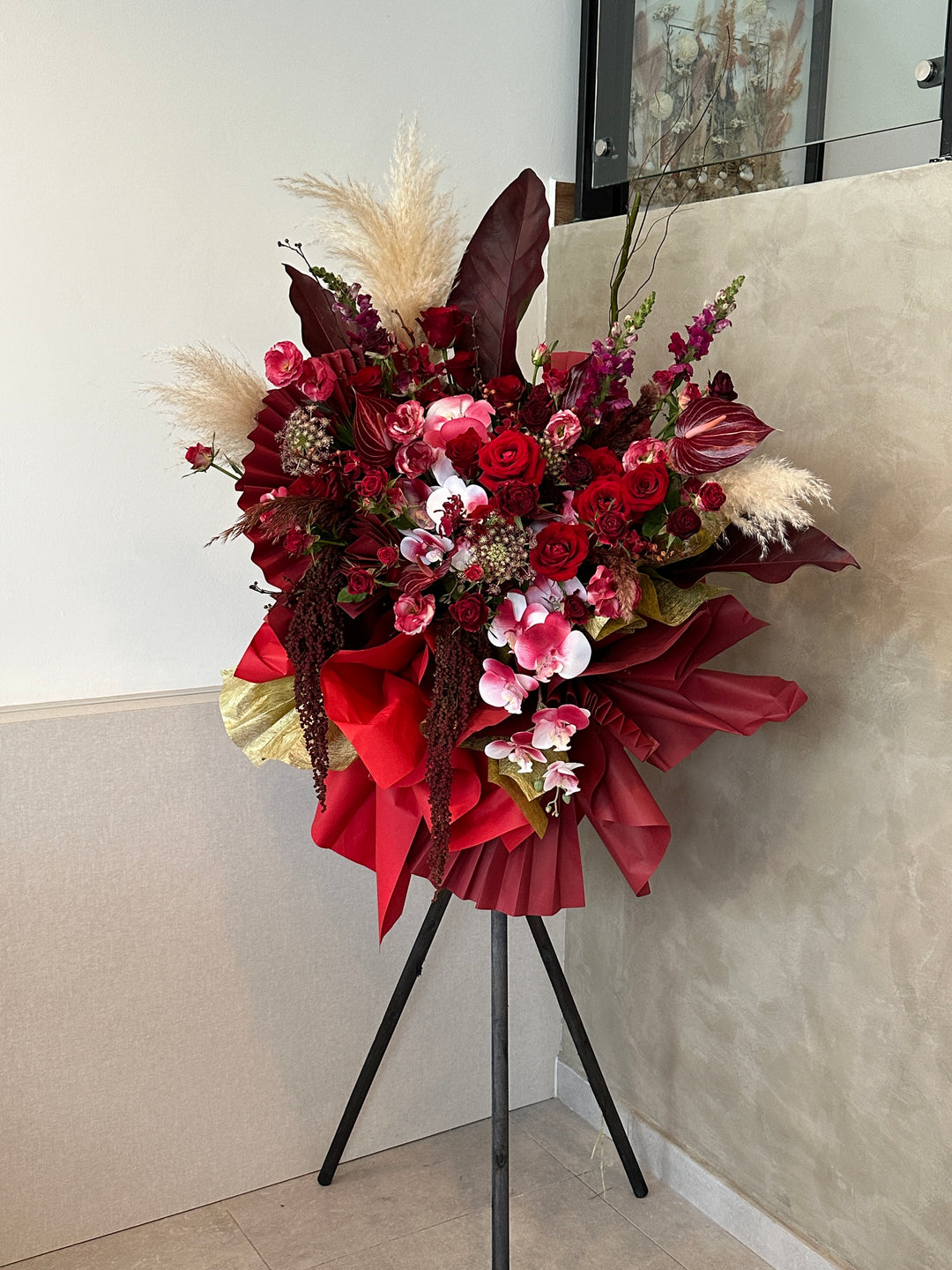  an arrangement of vibrant red flowers symbolizing success and celebration, flower delivery in penang