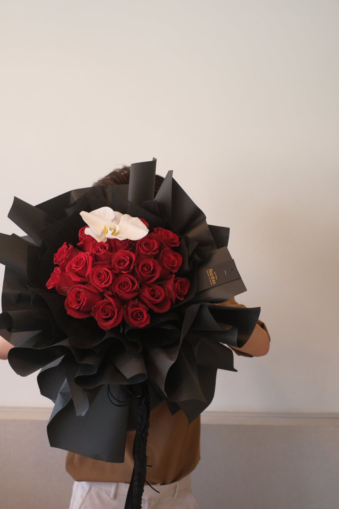 red roses in black wrapping