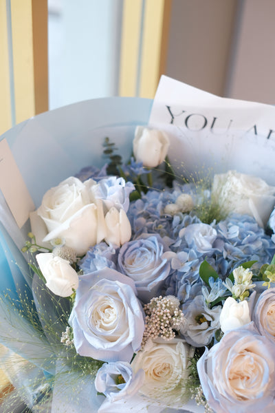  flowers complemented with a sea of blue perfection featuring hydrangeas, roses, eustomas, tulips, and assorted fillers.