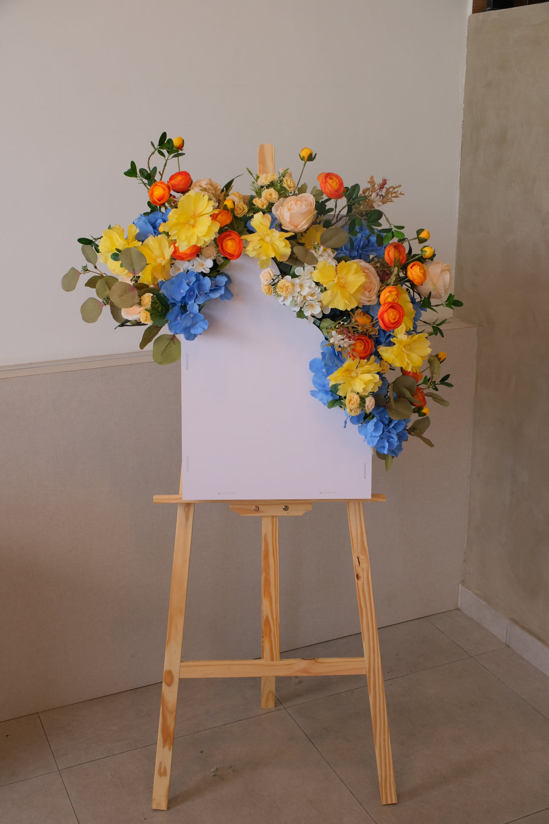 Vivid Bloom Grand Opening Stand by Bamboo Green Florist Penang – bold blue and yellow artificial flower arrangement on a wooden stand for business openings