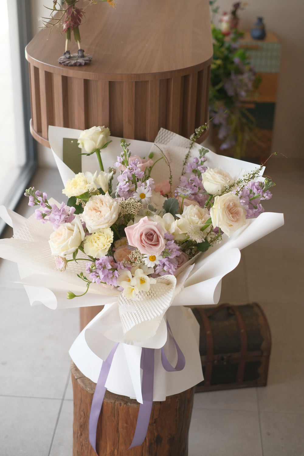 proposal bouquet with roses in cream wrap