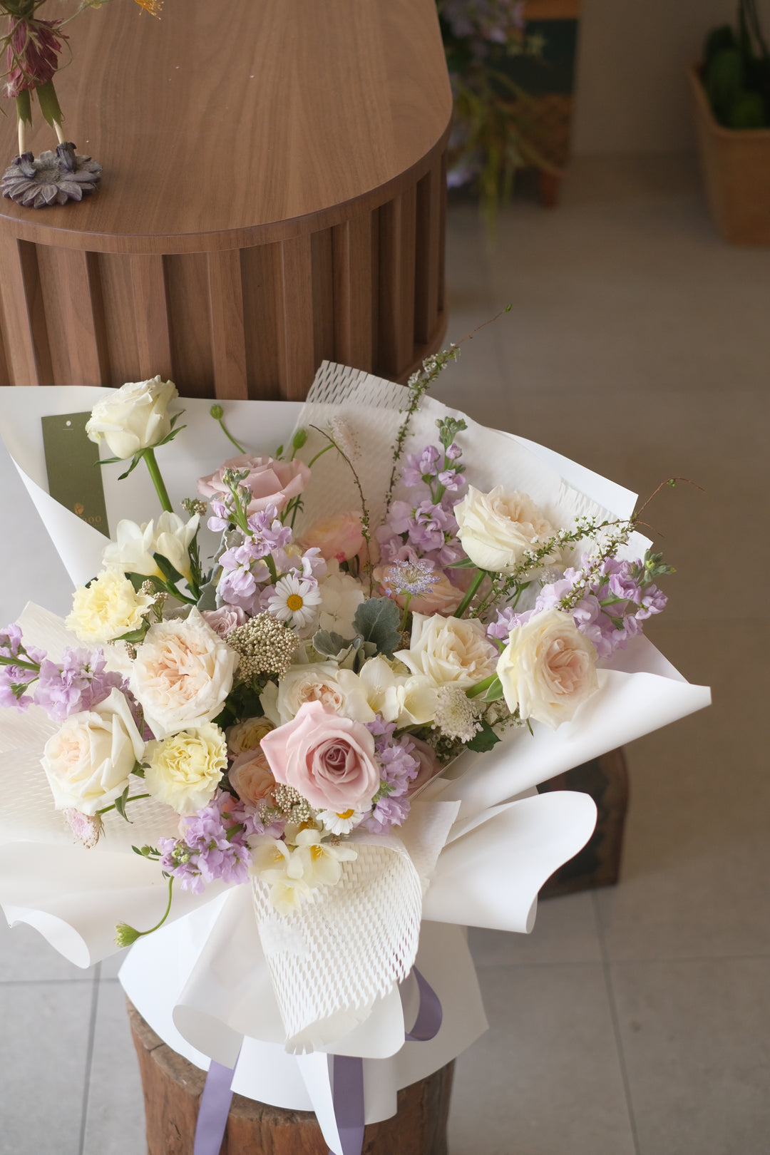 bouquet of cream roses in white wraps