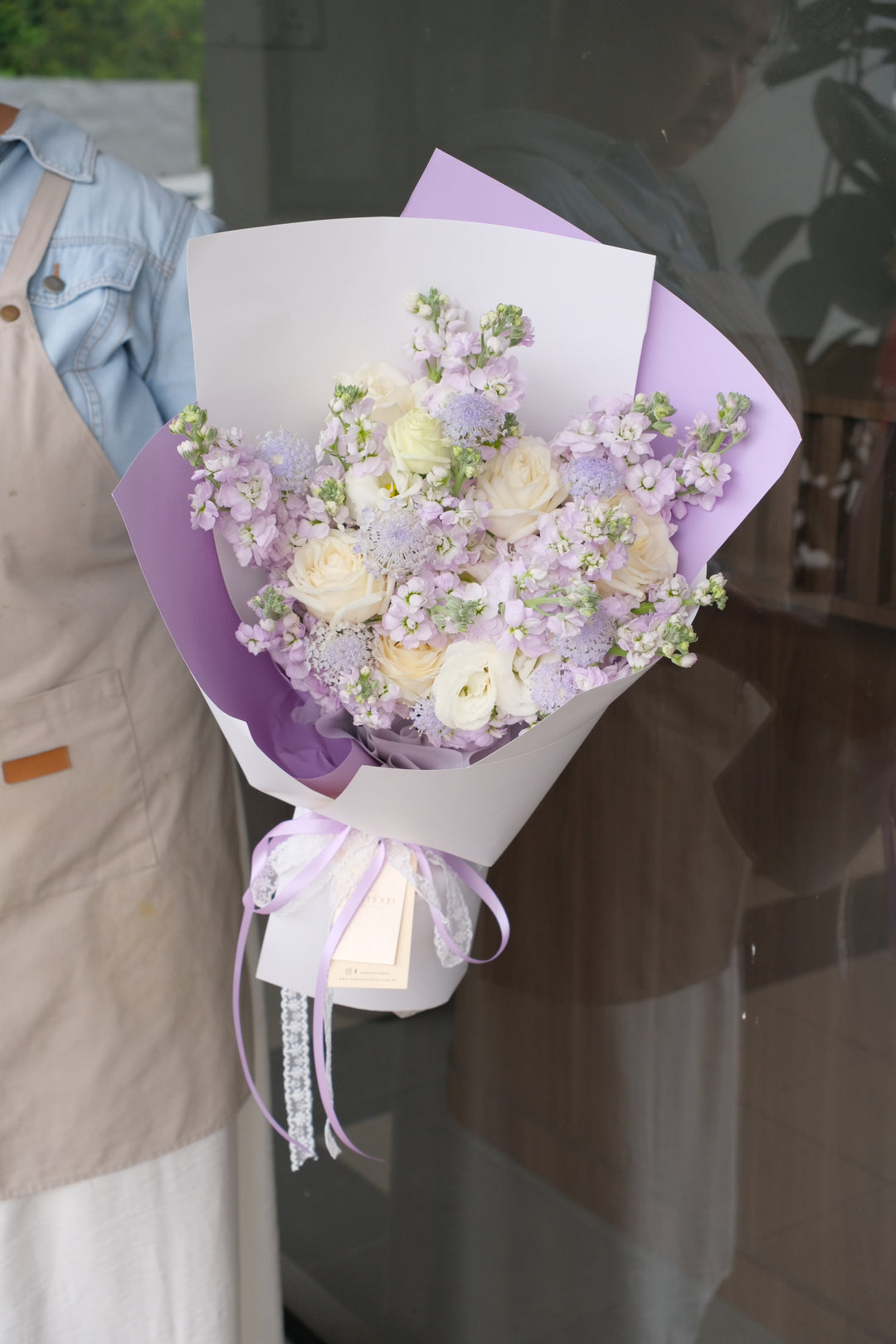 7 Xi bouquet with purple matthiolas, white roses, and eustoma