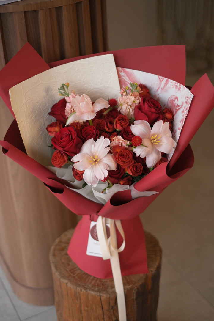 Red roses, chocolate brown spray roses, tulips, and matthiolas create a stunning, vibrant bouquet. Premium roses, elegant floral arrangement, luxury flowers, Penang florist.