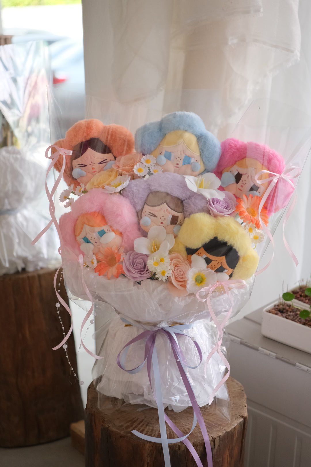 Crybaby Bouquet with six pastel plush toys and soap flowers wrapped in white and transparent layers – Bamboo Green Florist Penang graduation gift