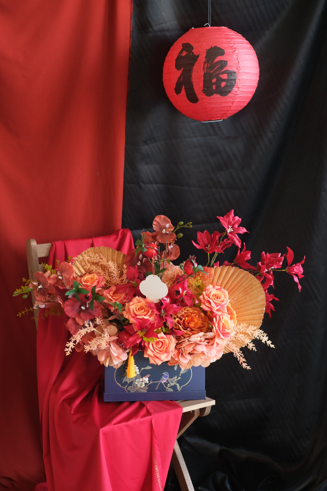 Lush red pomegranates, hydrangeas, and peonies with gold fan accessories, symbolizing prosperity and love. Penang florist, order online, deliver same day, artificial flowers.