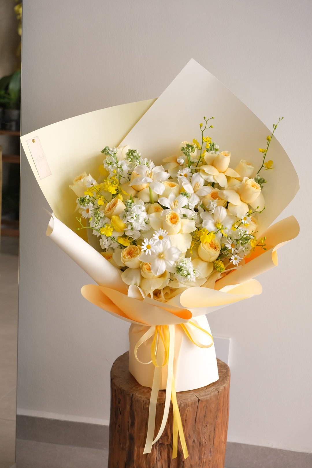 Butter-yellow bouquet of butterscotch garden roses, white star orchids and daisies, hand-tied by Bamboo Green Florist Penang