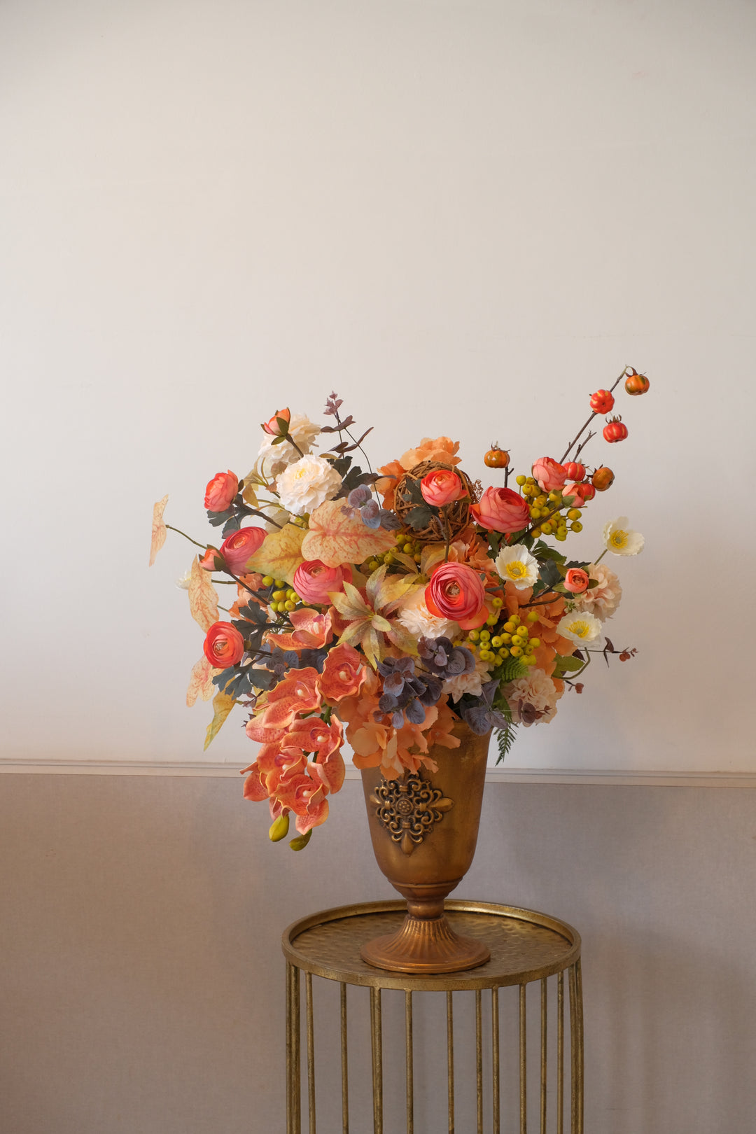 bouquet of bright orange flowers in gold metal pot
