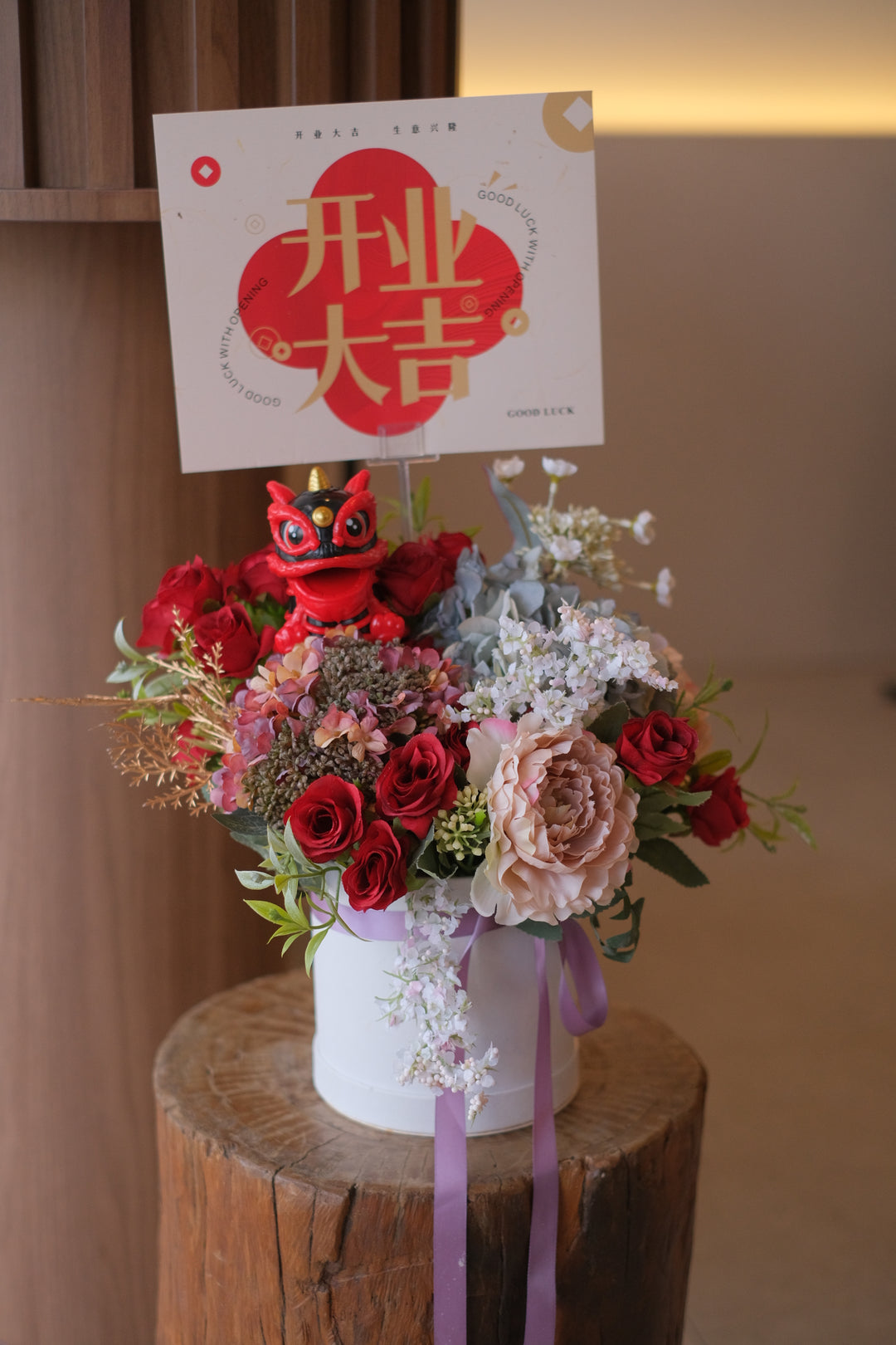 Celebrate new beginnings with vibrant artificial flowers and a lion dance figurine, symbolizing good fortune and prosperity. Order online from Bamboo Green Florist, Penang. Same-day delivery available.