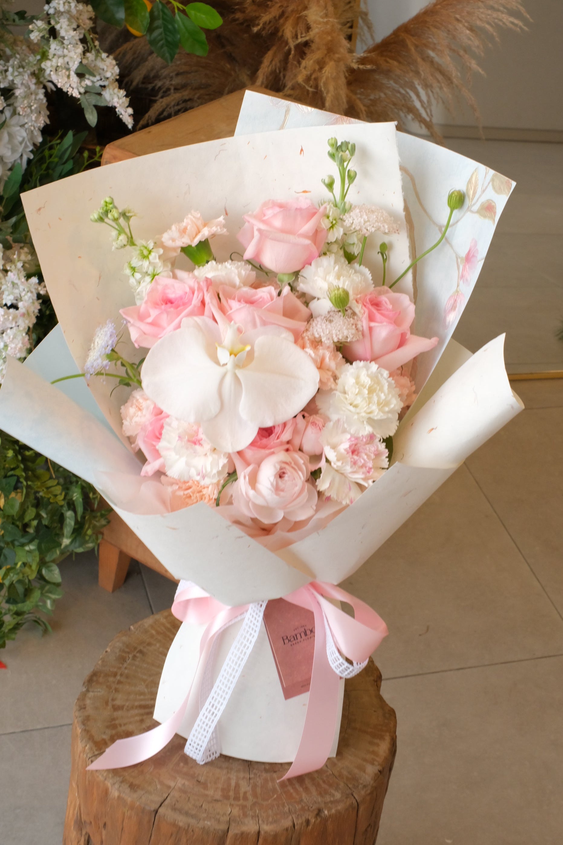 bouquet of white orchids, pink roses and carnations for mother's birthday