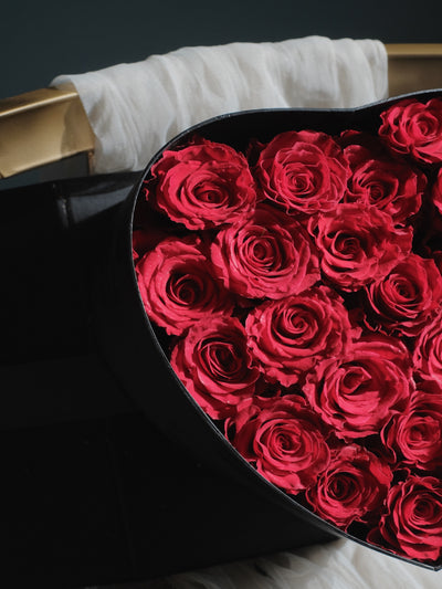 a bouquet of rose in red and black wrapper 