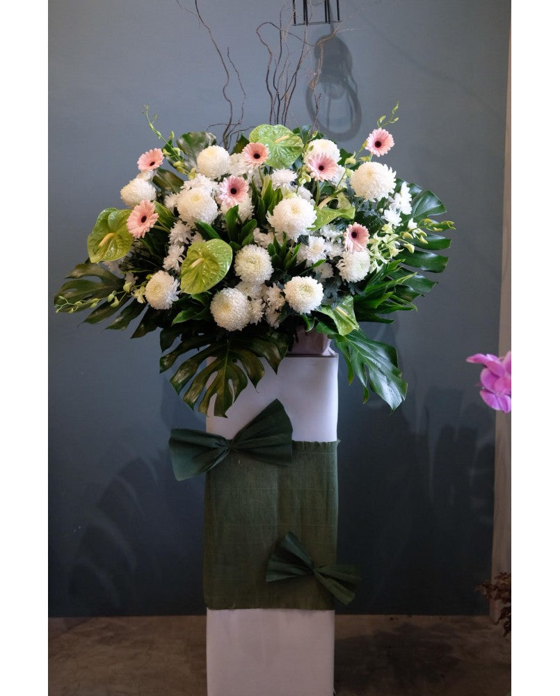 This 1 tier consists of classic condolences flower such as white chrysanthemum, pink gerberas, anthuriums, orchids speaks all your comforting words to the mournful heart, for same day condolences flowers delivery in Penang.  