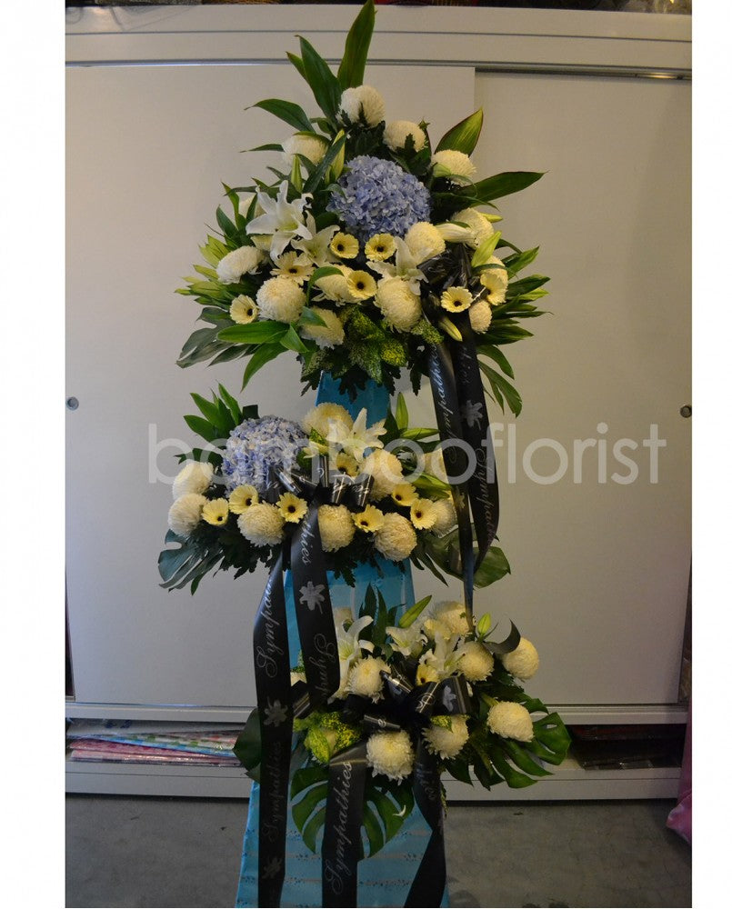 This lovely floral testament to the circle of life and love evokes beautiful memories even during the most difficult times. For same day condolences flowers delivery in Penang.  