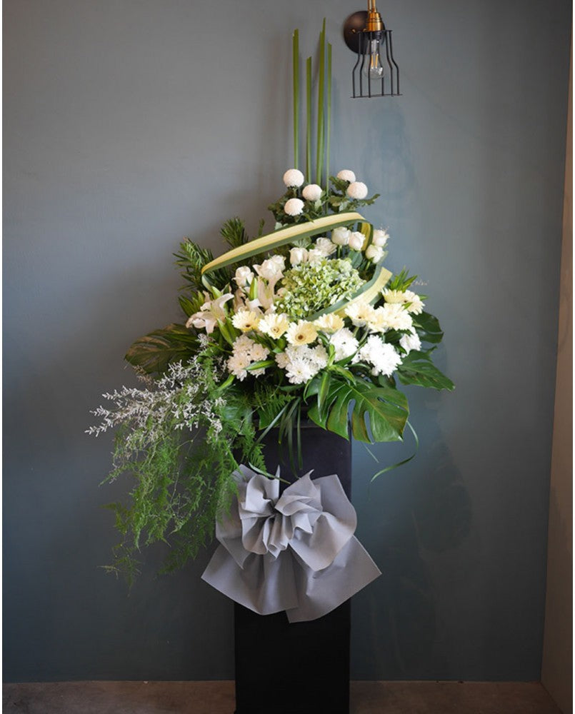 Let the family members know you care and understand with a simple gesture with the funera condolencesl stand comprises with hydrangea, roses, daisies, ping pongs, lilies and lush ferns. For same day condolences flowers delivery in Penang.