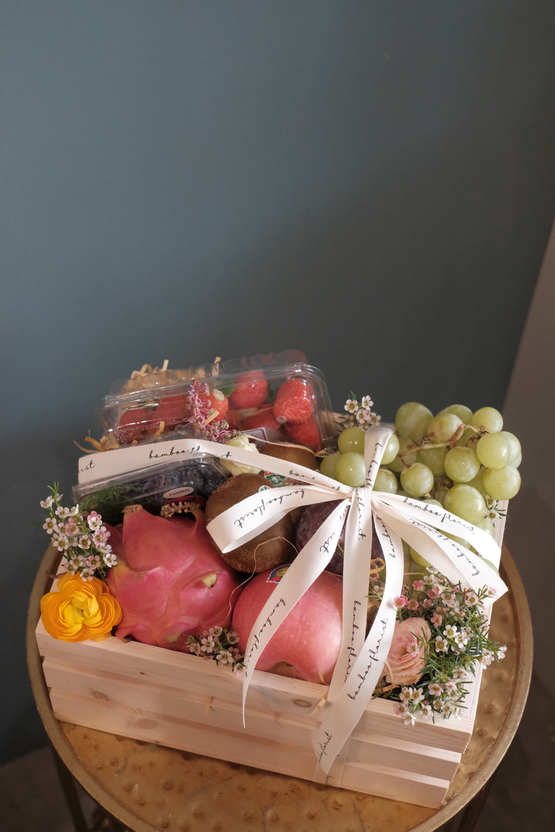 Finding the perfect fruit basket to delivery in Penang? "The Covent Fruit Co"   - fresh fruits deliver in a wooden crate, this set includes grapes, kiwis, apples, dragon fruit, strawberries, blueberries, plum & honeydew (seasonal). Finishing off with fresh flowers of the day. Same day fruit basket delivery in Penang