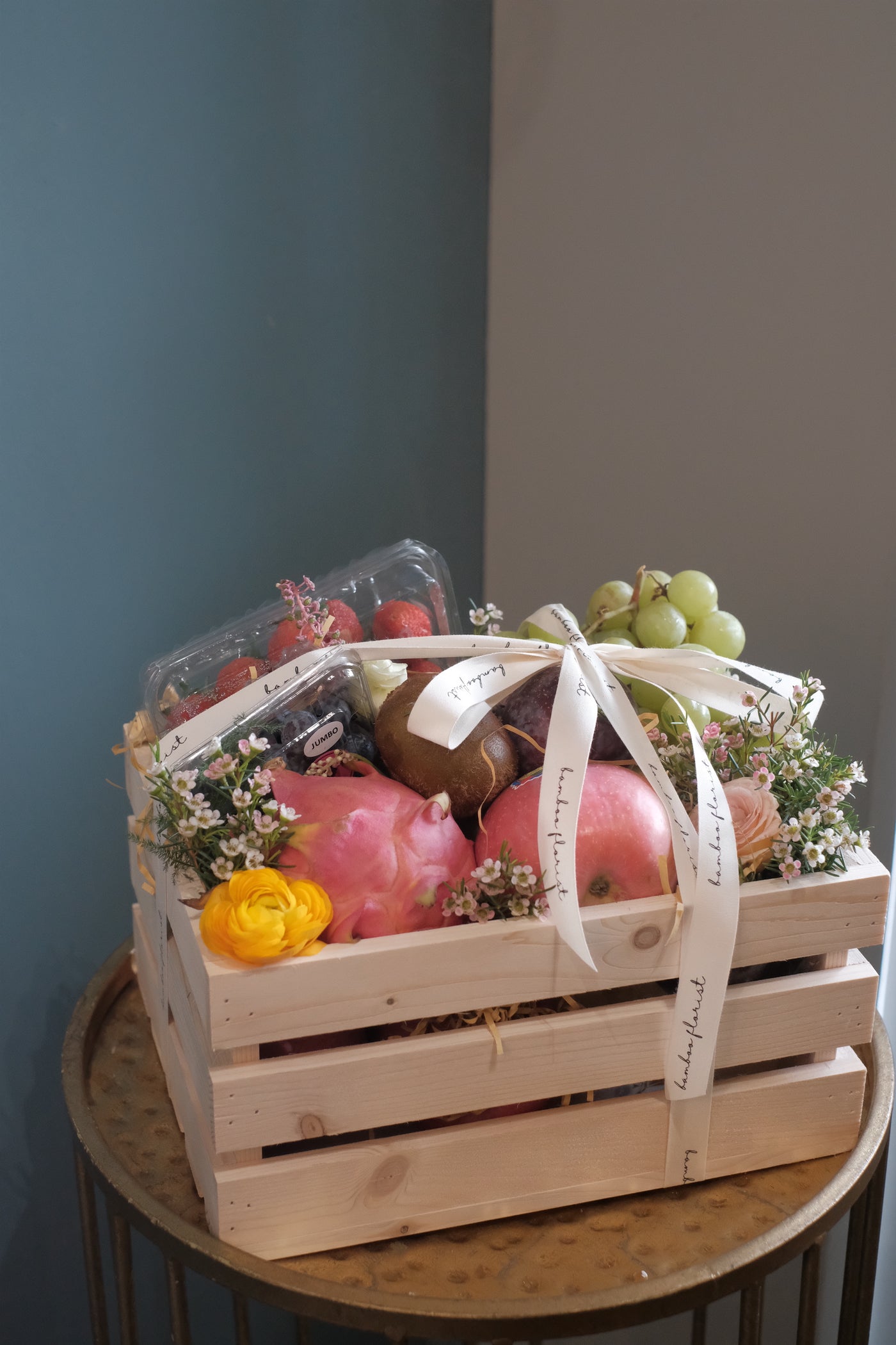 Finding the perfect fruit basket to delivery in Penang? "The Covent Fruit Co"   - fresh fruits deliver in a wooden crate, this set includes grapes, kiwis, apples, dragon fruit, strawberries, blueberries, plum & honeydew (seasonal). Finishing off with fresh flowers of the day. Same day fruit basket delivery in Penang