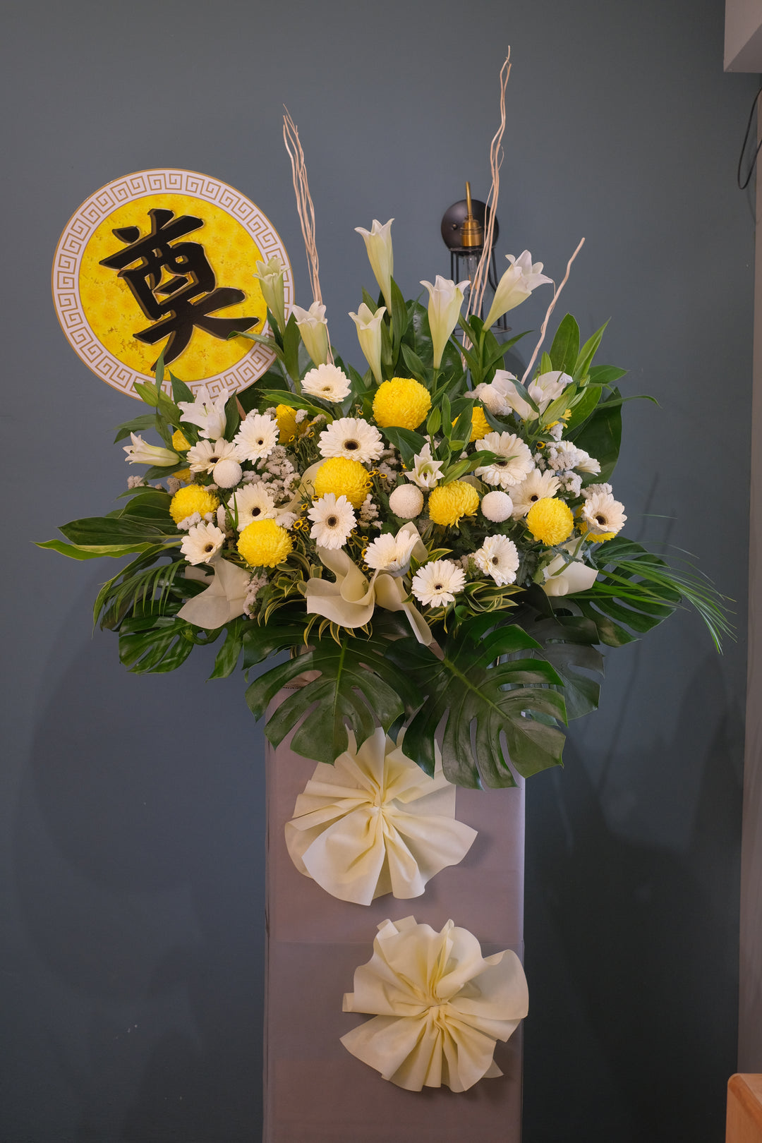 Composed with lilies, chrysanthemums, daisies and fillers to express condolences and heartfelt sympathies. For same day condolences flowers delivery in Butterworth