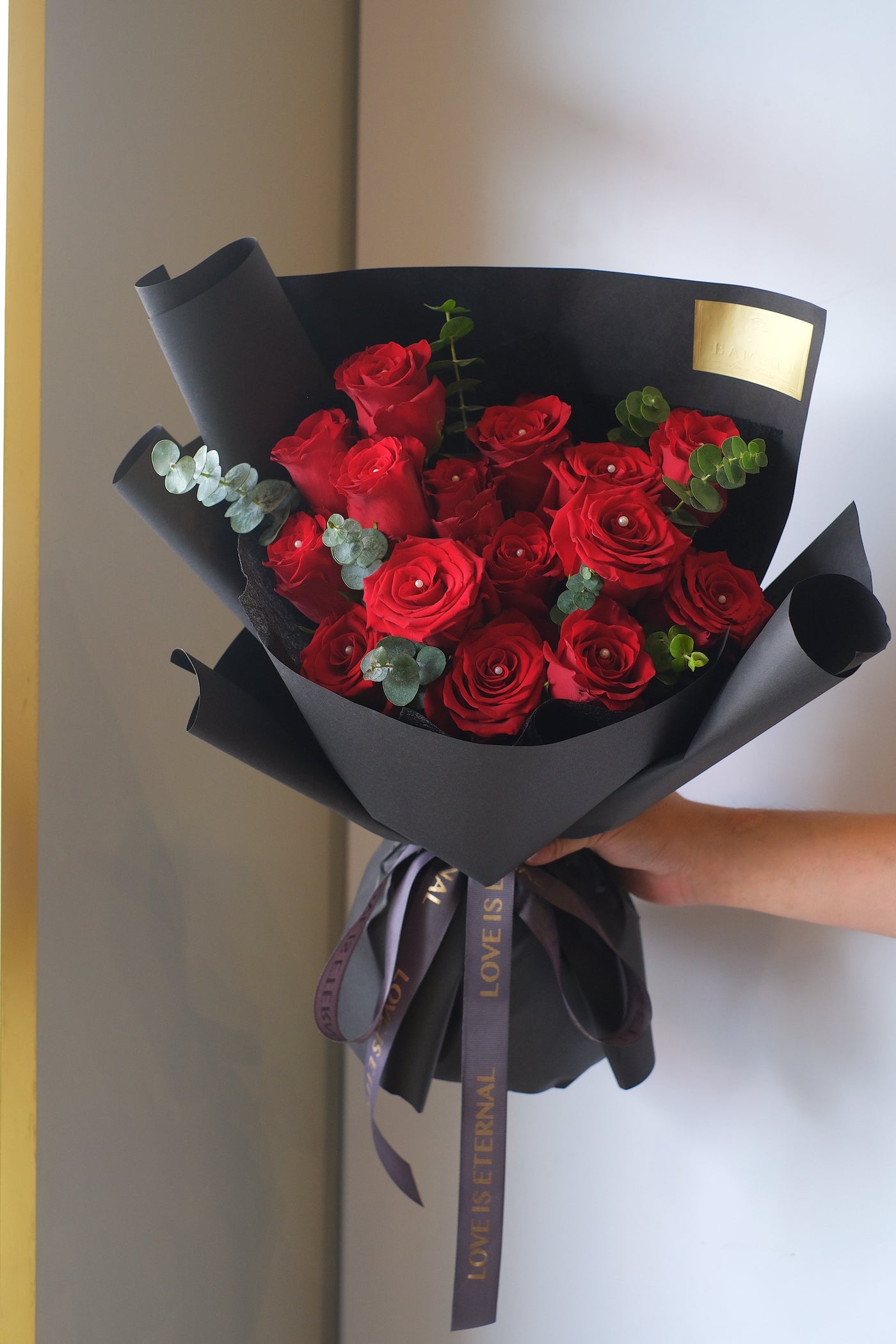 Express your romance with this  pristine red roses with eucalyptus leaves, in a classical black wrap. 