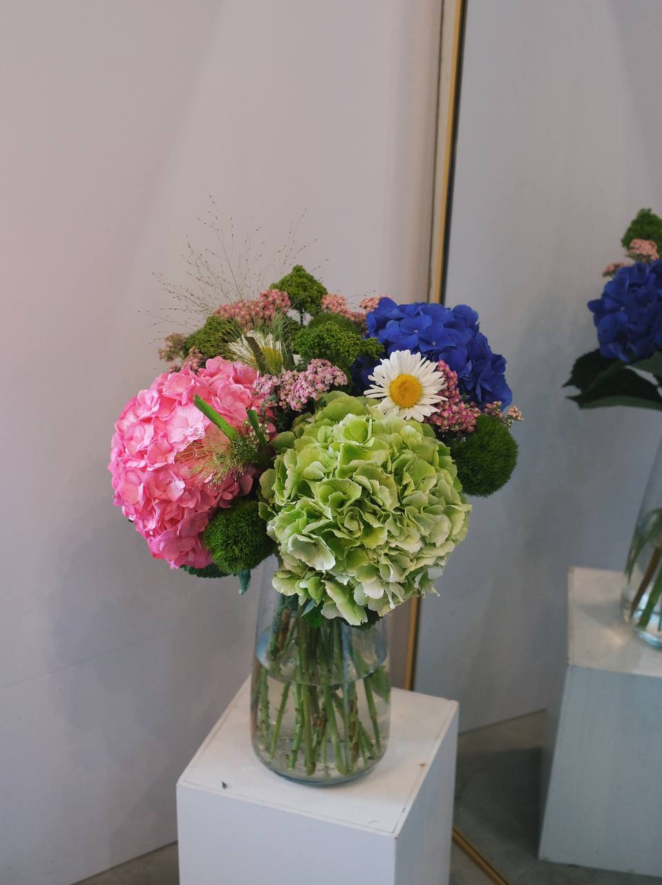 Hydrangeas in a variety of colors, paired with seasonal fillers and leaves, create a beautiful, gender-neutral arrangement. Available for same-day delivery by Penang Florist.