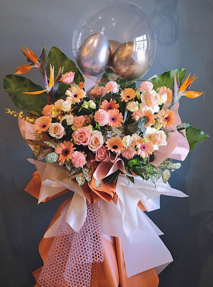 Emulate the success of this towering congratulatory stand. Stand all among our impressive hydrangeas, multi-coloured gerberas, bird of paradise, roses and other matching flowers and greens. For same day grand opening congratulations flowers delivery in Penang and Butterworth.