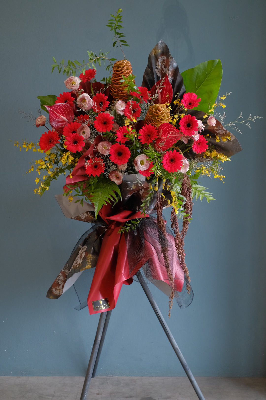 An omakase fresh flowers opening stand series, designed by our florist.   This piece will be arrange in a palette of red, burgundy, yellow to fit in any space. For same day grand opening congratulations flowers delivery in Penang and Butterworth.