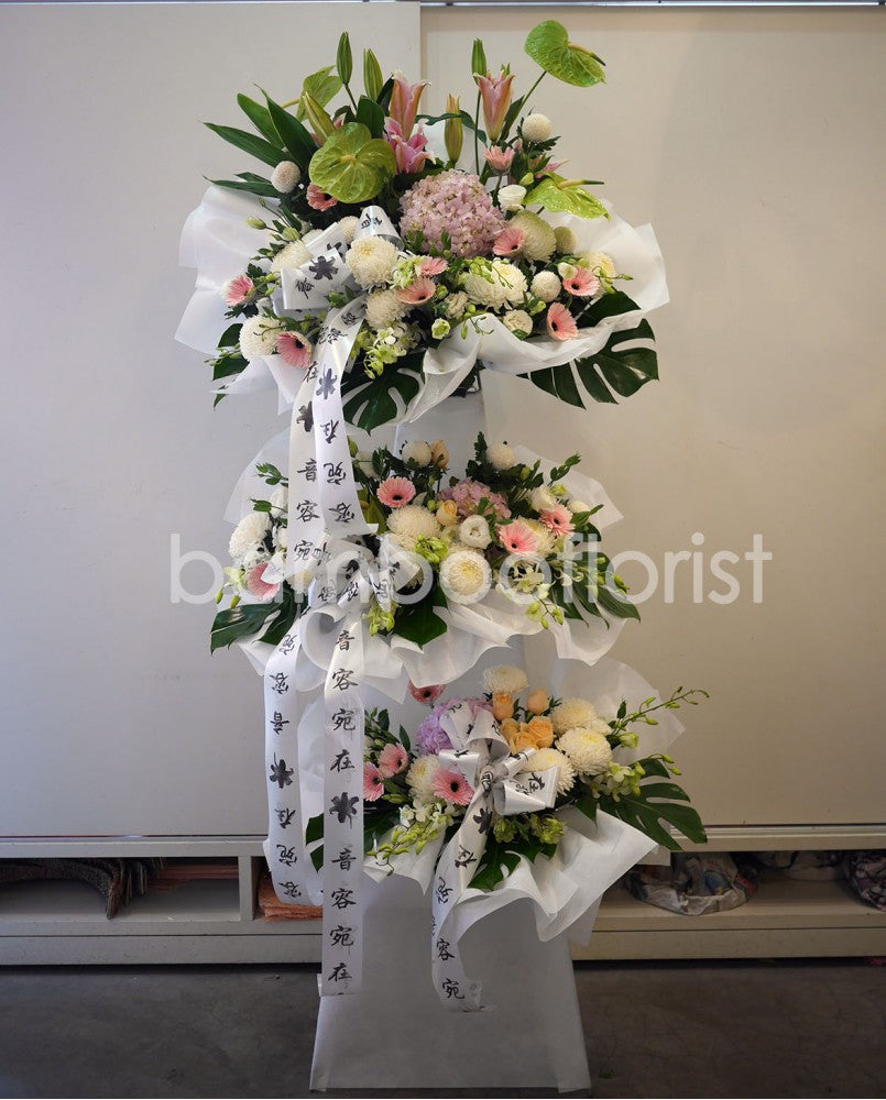 Memories are never forgotten but kept in prayers and always in our Hearts. Say it well with this soft pastel stand of hydrangeas, madonna lilies, gerbera, roses, anthuriums, orchids, eustoma, chrysanthemums and ferns. For same day condolences flowers delivery in Penang.