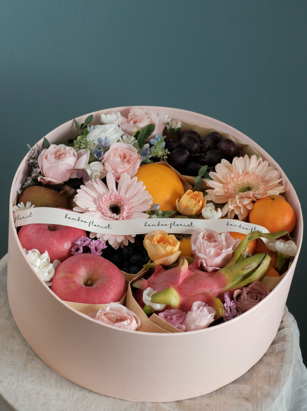 The tray where all the amazing fresh fruits & flowers went. Same day fruit basket delivery in Penang and Butterworth. Fruits included:: Fruits of the Day, 7 types of fresh exotic & seasonal fruits.     size of box : diameter 38cm x height 15cm 