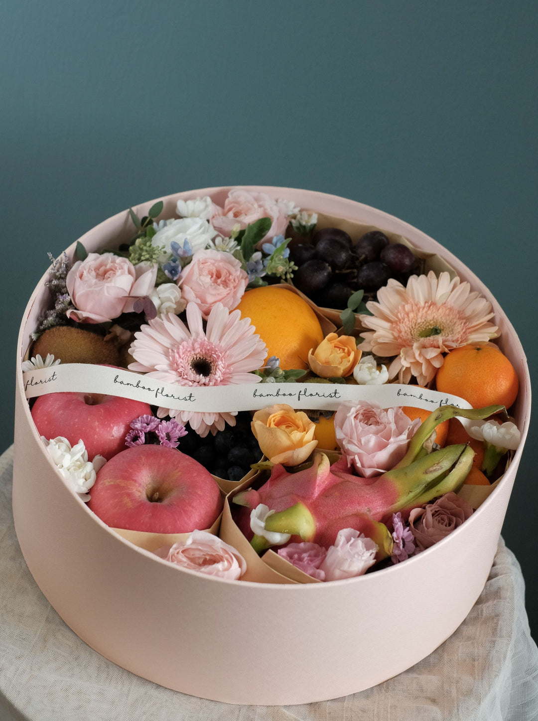 The tray where all the amazing fresh fruits & flowers went. Same day fruit basket delivery in Penang and Butterworth. Fruits included:: Fruits of the Day, 7 types of fresh exotic & seasonal fruits.     size of box : diameter 38cm x height 15cm 