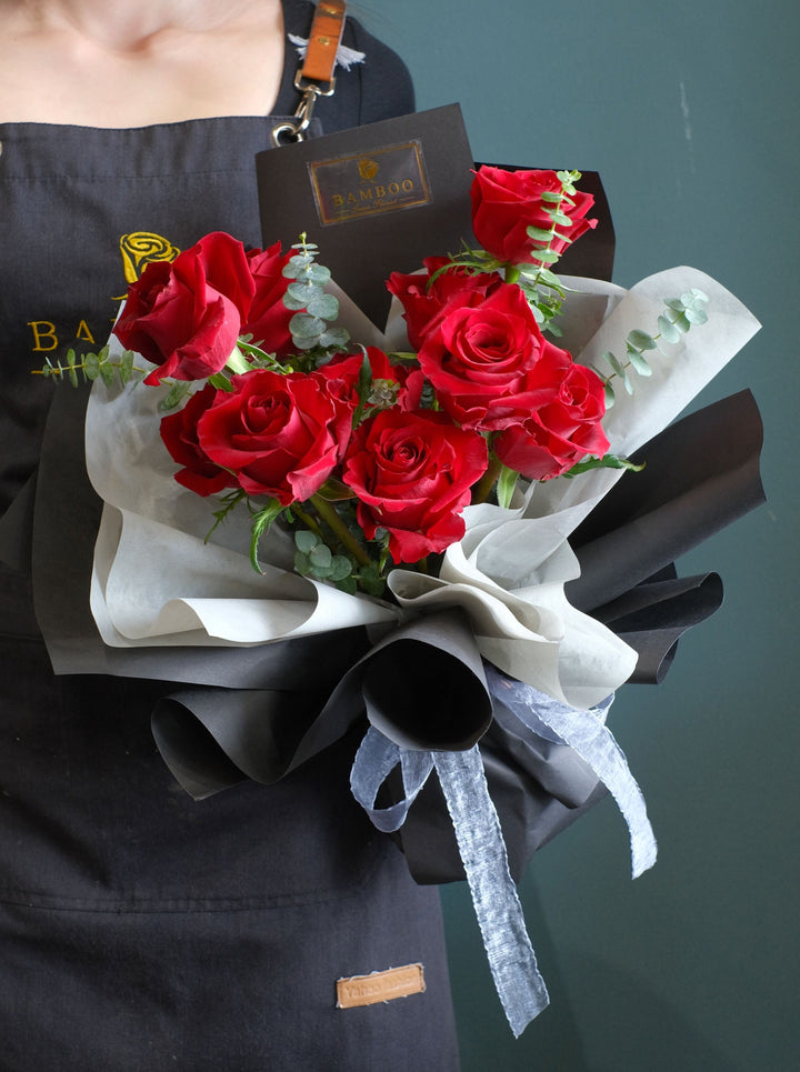Express your romance with this Premium Ecuadorian red roses with eucalyptus leaves, in a classical black wrap for valentine's day flowers delivery.  Photo shown 12 stalks red roses bouquet. Same day delivery florist penang