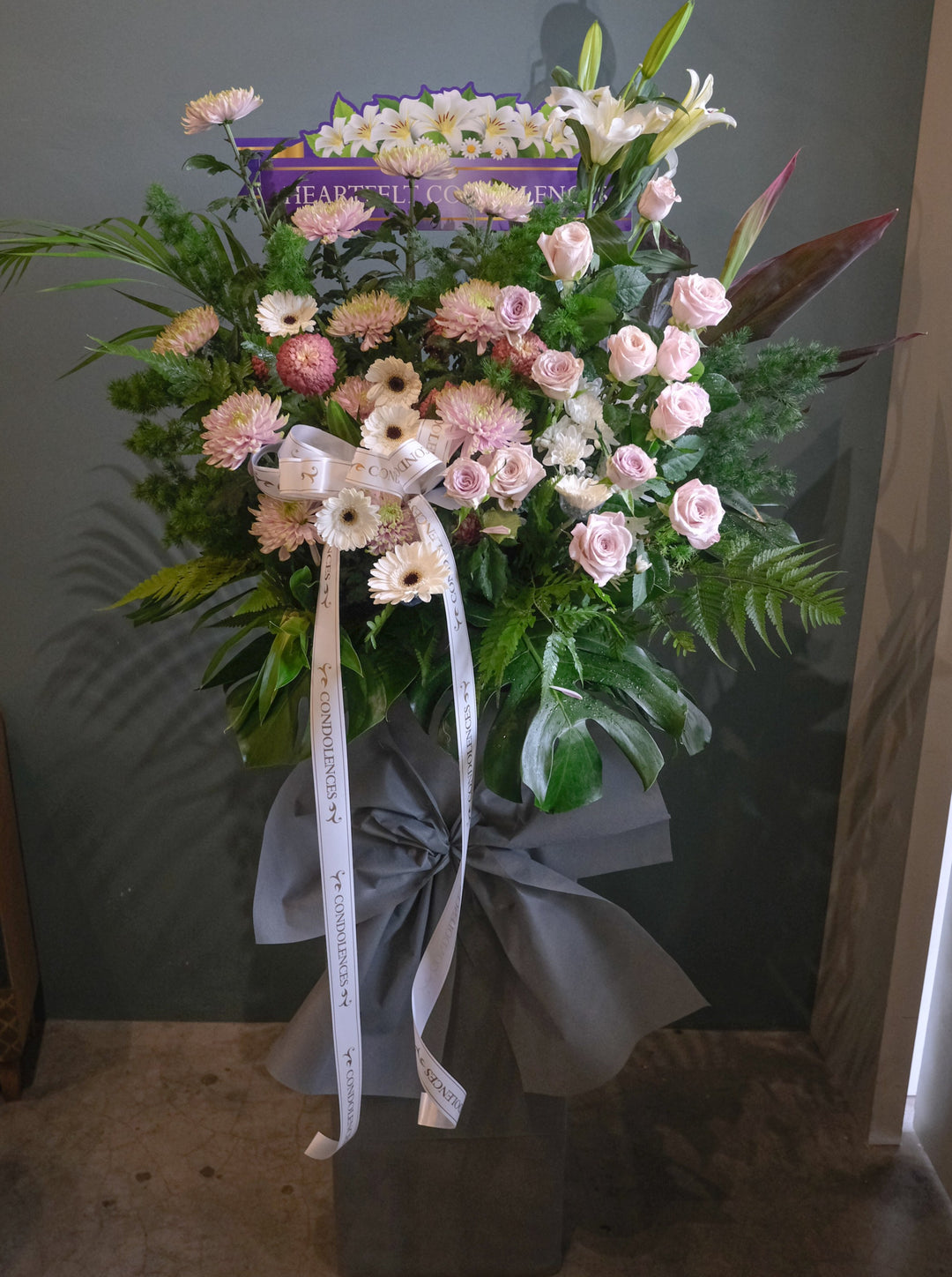 When a loved one or friend leaves us, it is never easy. At times, we may be lost for words, or fail to find the right ones to articulate our comfort and condolences. Say it with flowers, graceful and universally understood.     Flower size shown is STANDARD. For same day condolences flowers delivery in Penang.       Note: Florals used and final design will vary depending on seasonality and availability.