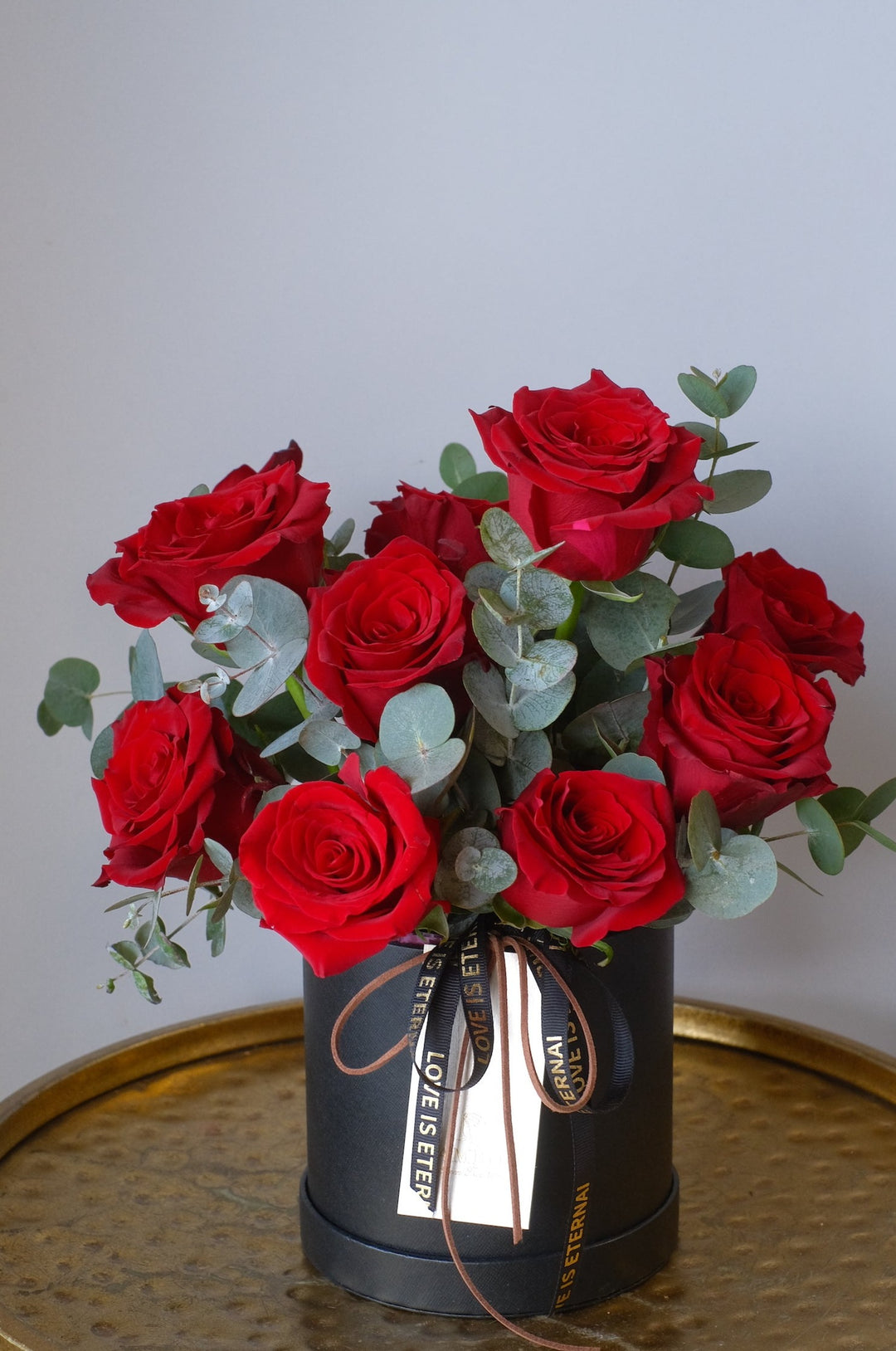 Stunning composition of 10 red luxury roses in elegant black box for valentine's flower delivery.